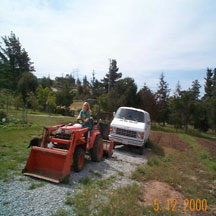 Sandi on tractor next to delivery van